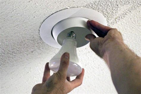 Take mounting bracket and remove the two 1/4″ long side screws. . How to change bulb in recessed ceiling light with cover